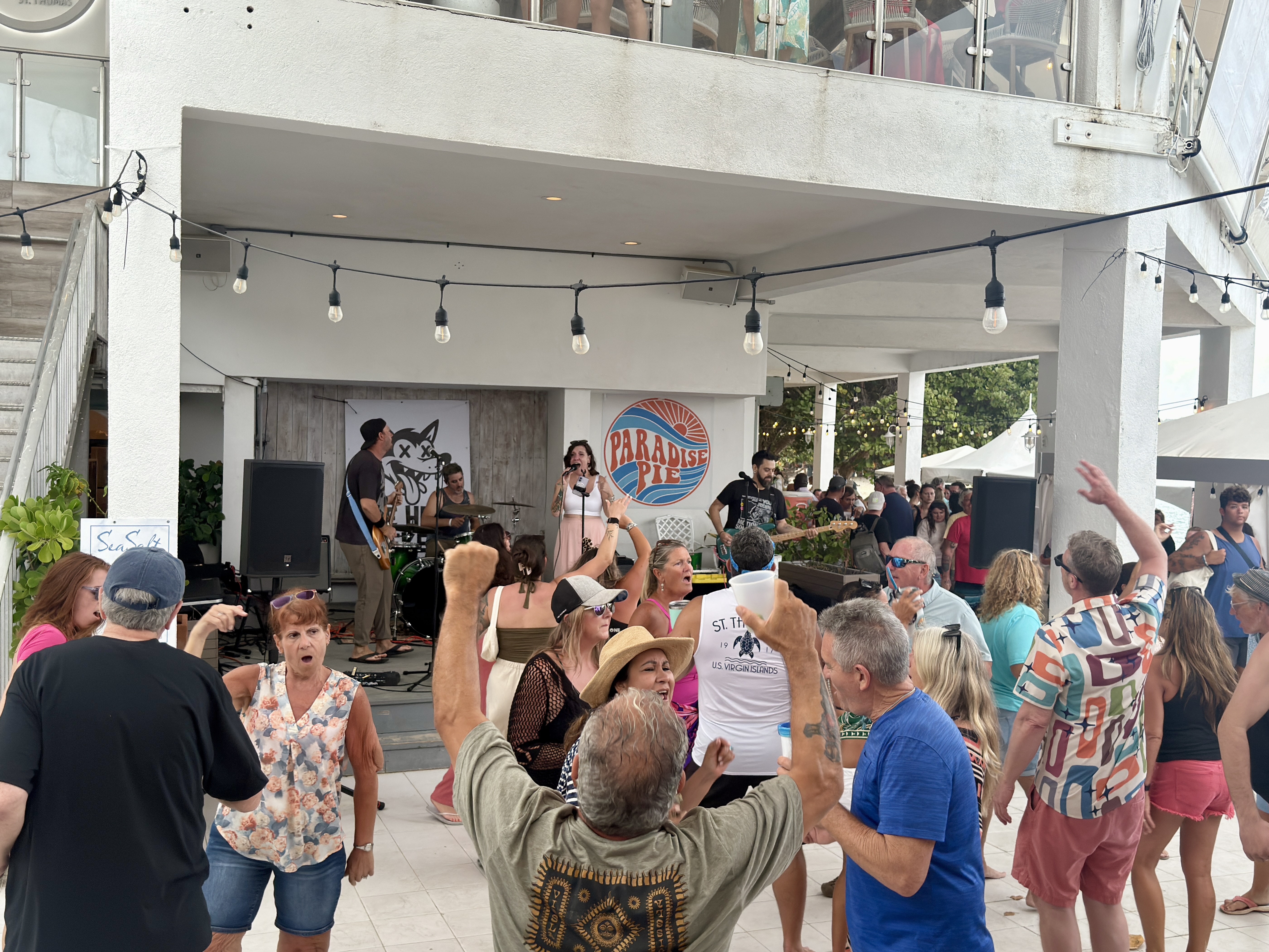 Crowd dancing and cheering during The Heat Seekers live show at Sapphire Beach Bar St Thomas