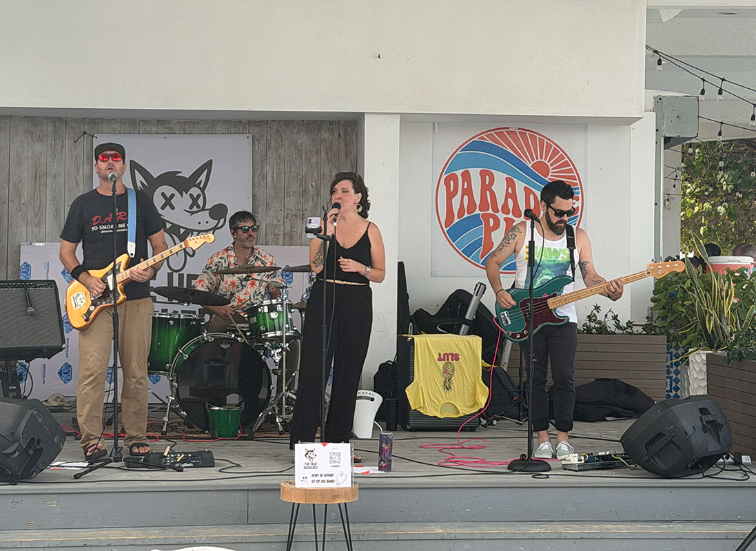 The Heat Seekers performing live at Sapphire Beach Bar St Thomas with Paradise Pie sign in background