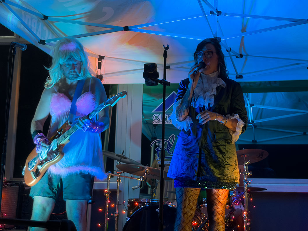 Heat Seekers guitarist and vocalist performing together in costume at a St Thomas live music event